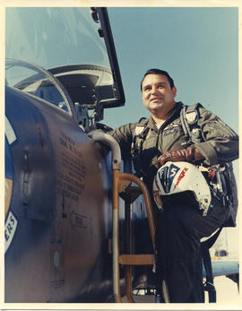 Photo: D.D. Bergie in flight Suit on Ladder next to Aircraft